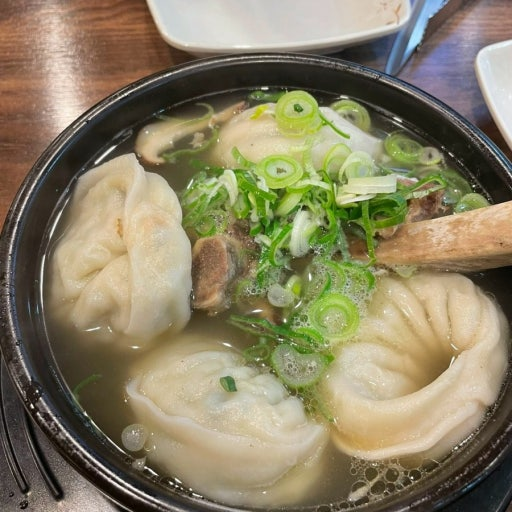 Galbitang Korean beef short rib soup served with mandu dumplings and green onions