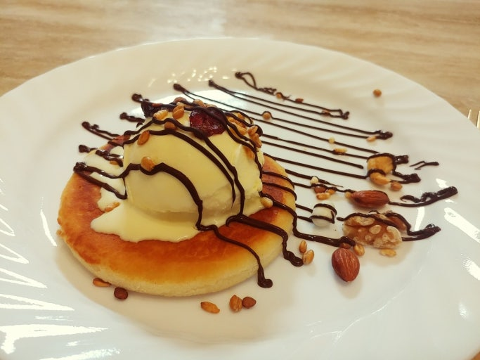 Hotteok Korean sweet pancake topped with vanilla ice cream and chocolate drizzle