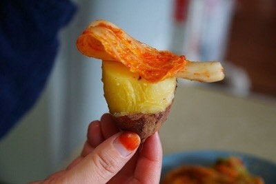 Roasted Korean sweet potato topped with spicy kimchi, a classic winter comfort food pairing