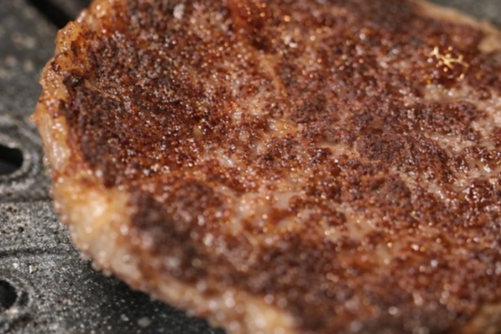 Seared Korean BBQ beef steak on a high-heat grill